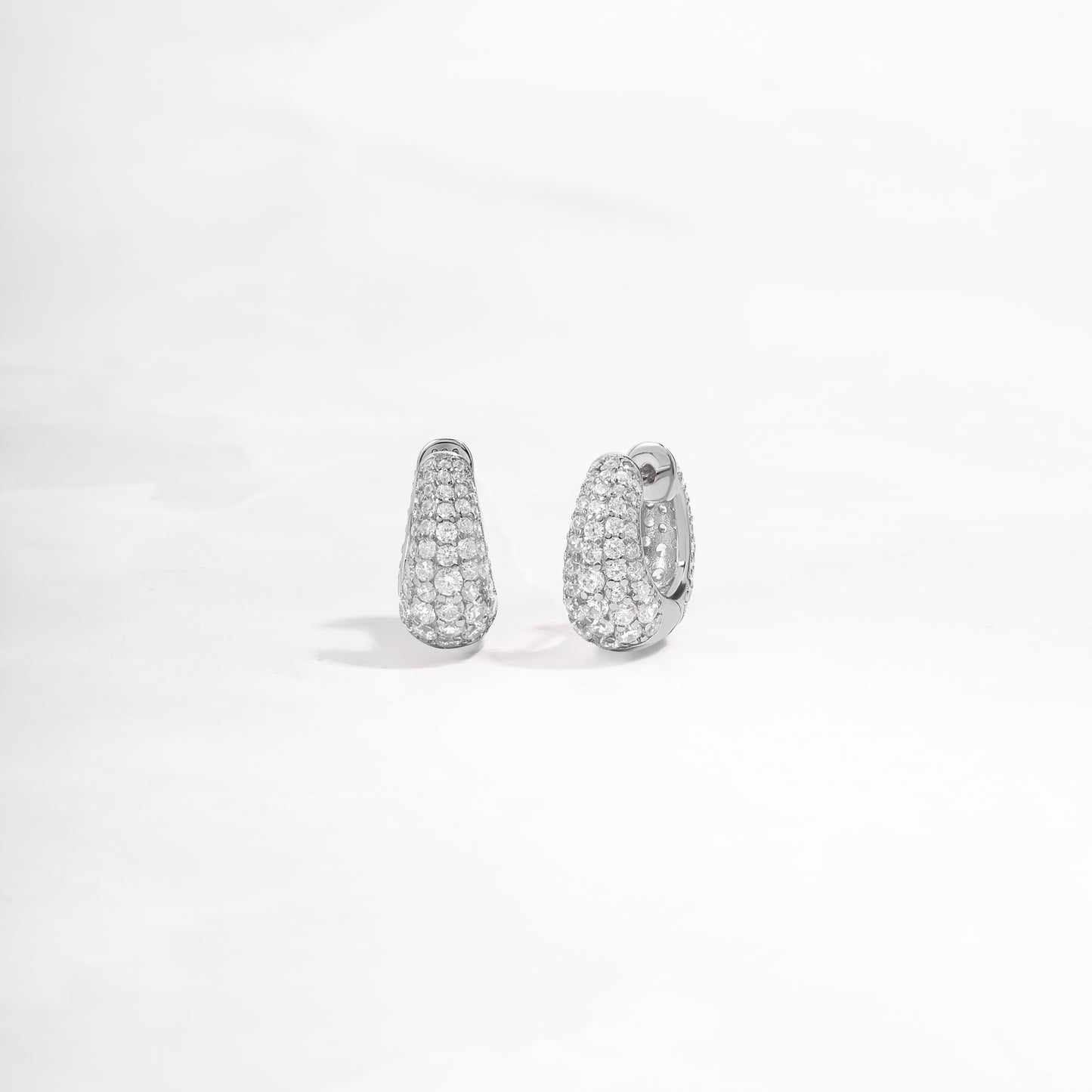 closeup image of sterling silver hoop earrings with cubic zirconia diamonds