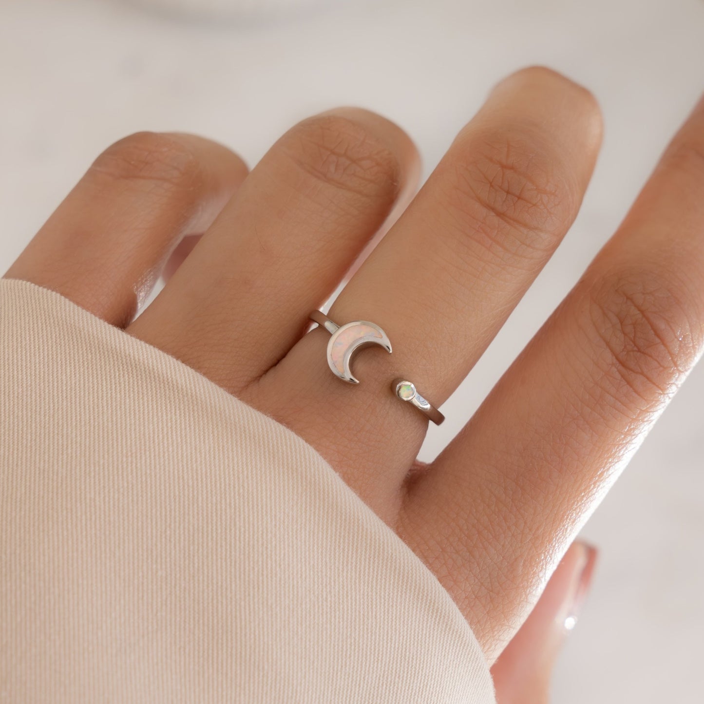 model wearing sterling silver adjustable opal ring