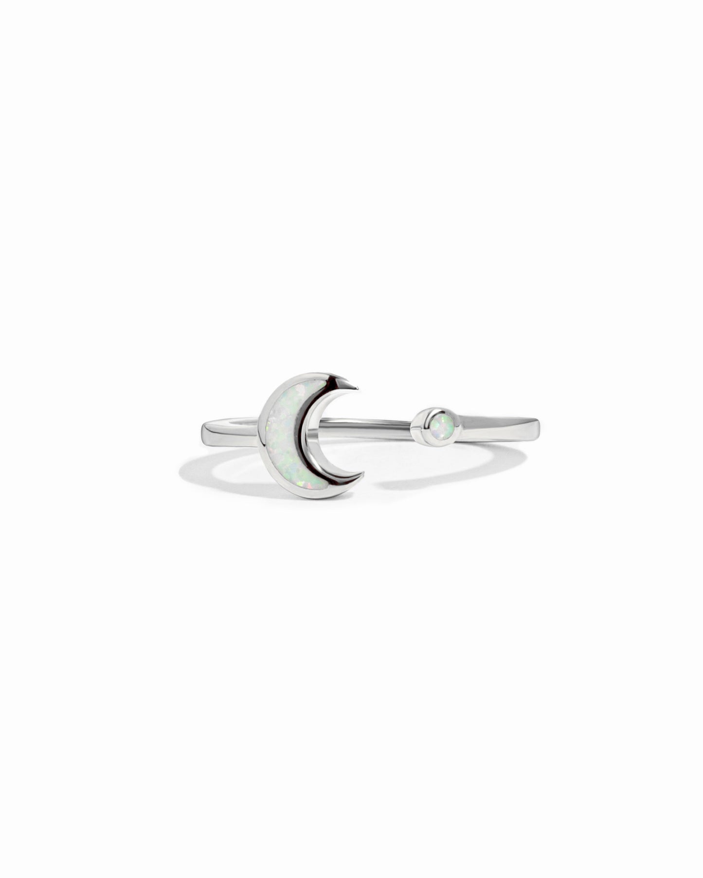 closeup image of silver opal ring with moon design