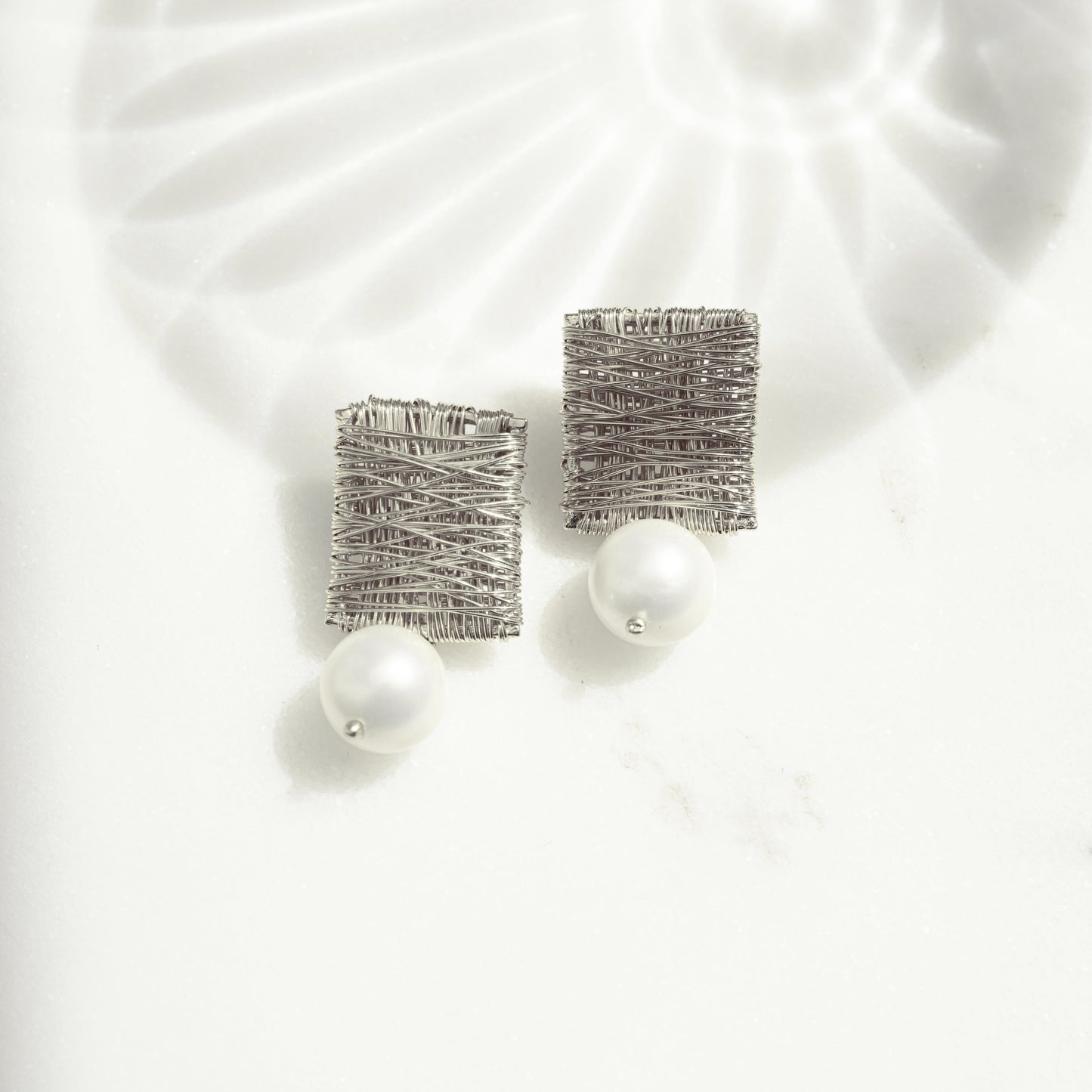 silver statement earrings featuring dangle drop earring design