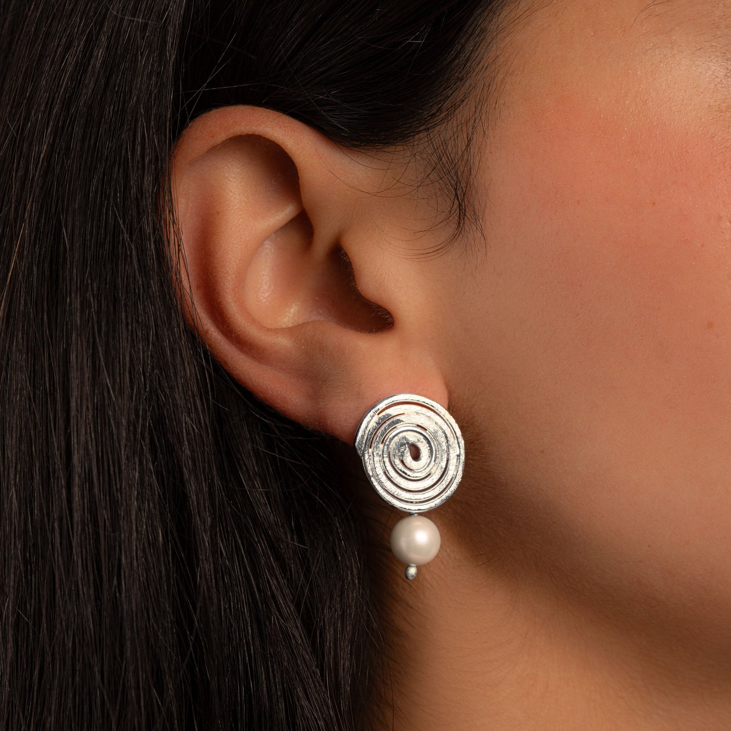 model wearing silver dangle earrings