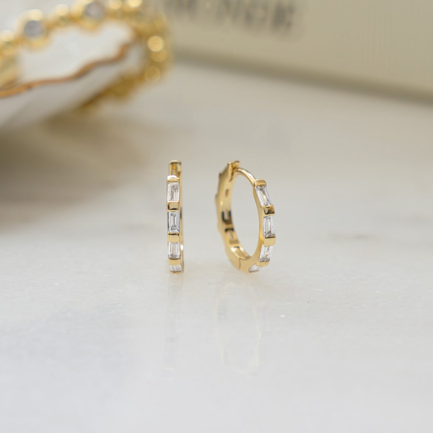 closeup image of small gold cz hoops