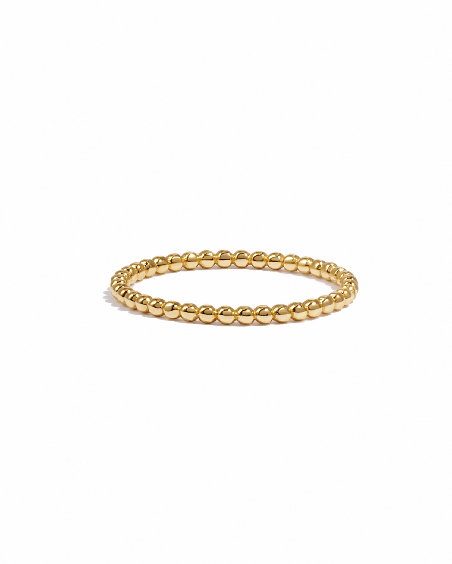 Gold beaded ring on a white background