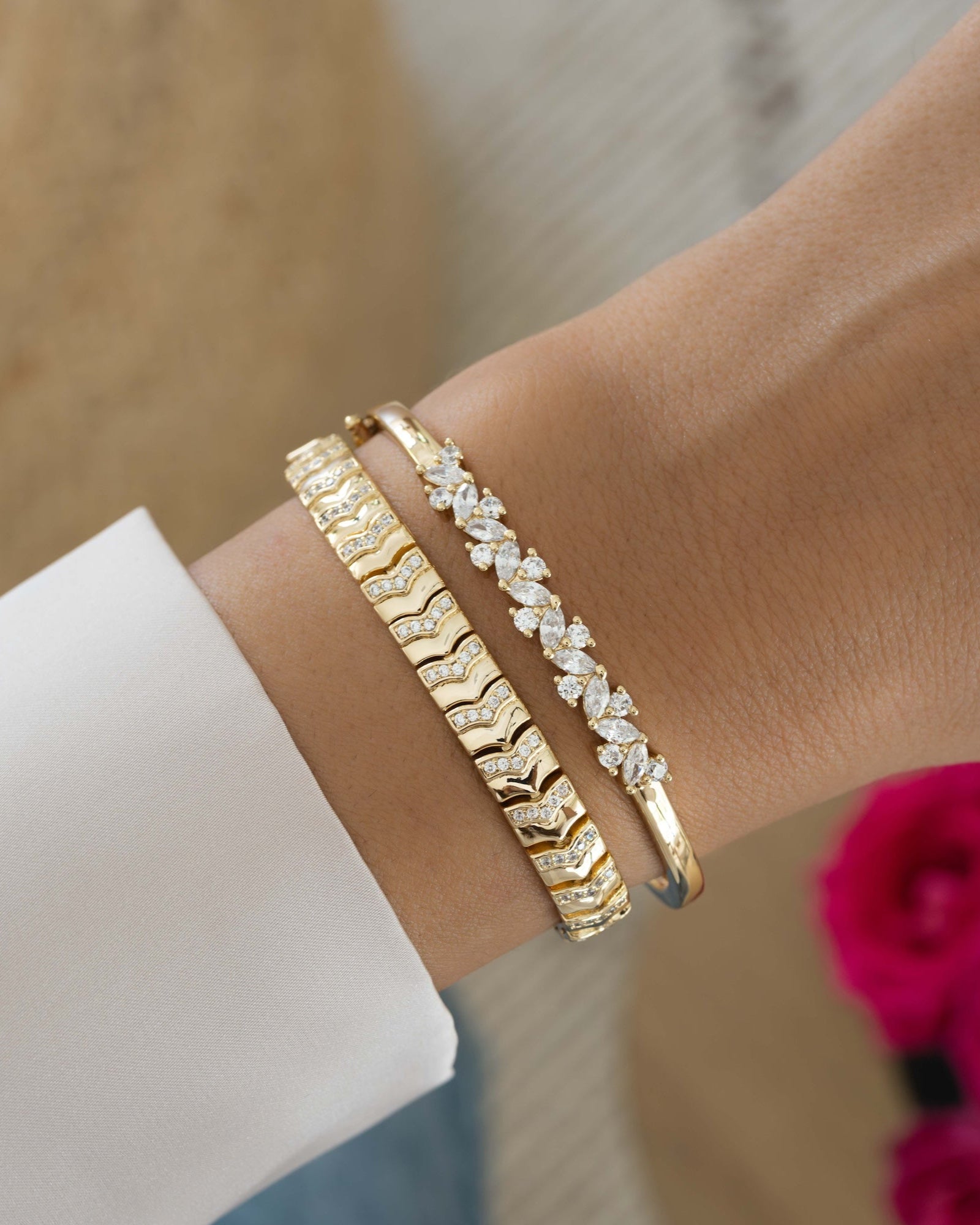 Model wearing gold vintage bracelets featuring a gold chain bracelet and a diamond bangle stacking bracelet