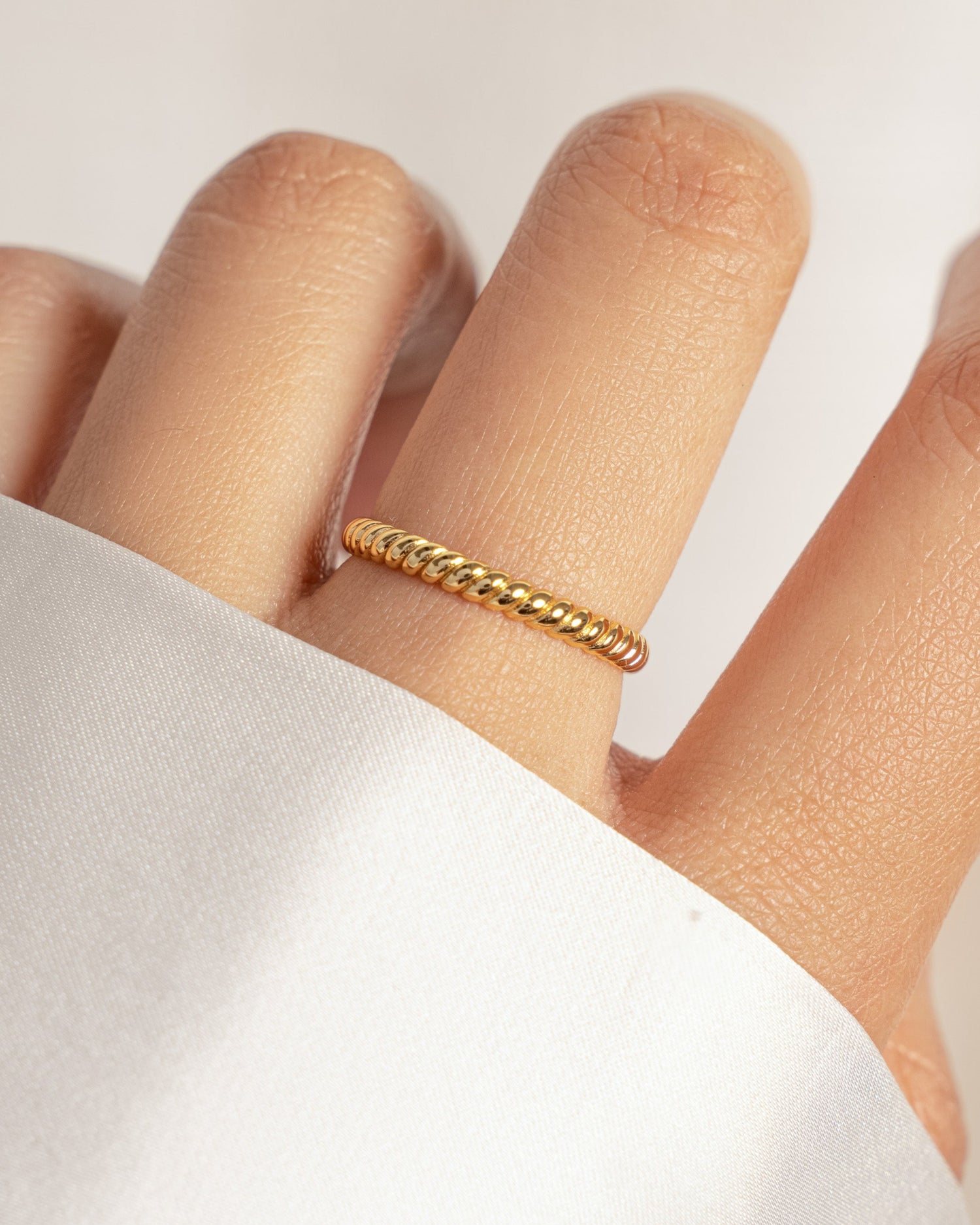model wearing gold rope ring