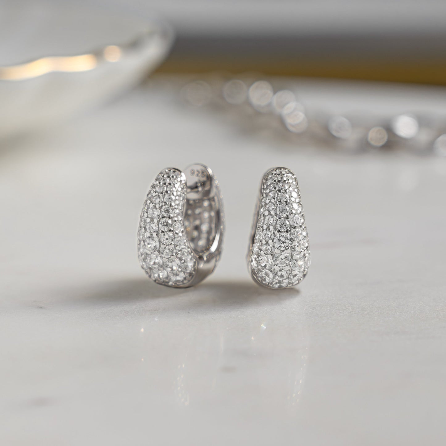 Closeup image of sterling silver diamond hoop earrings