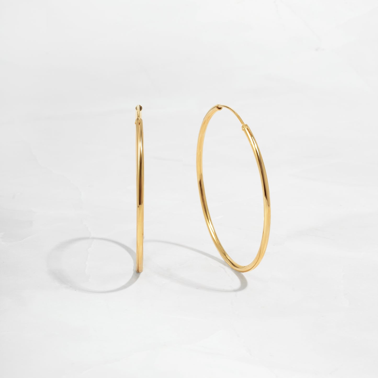 closeup image of dainty thin hoop earrings
