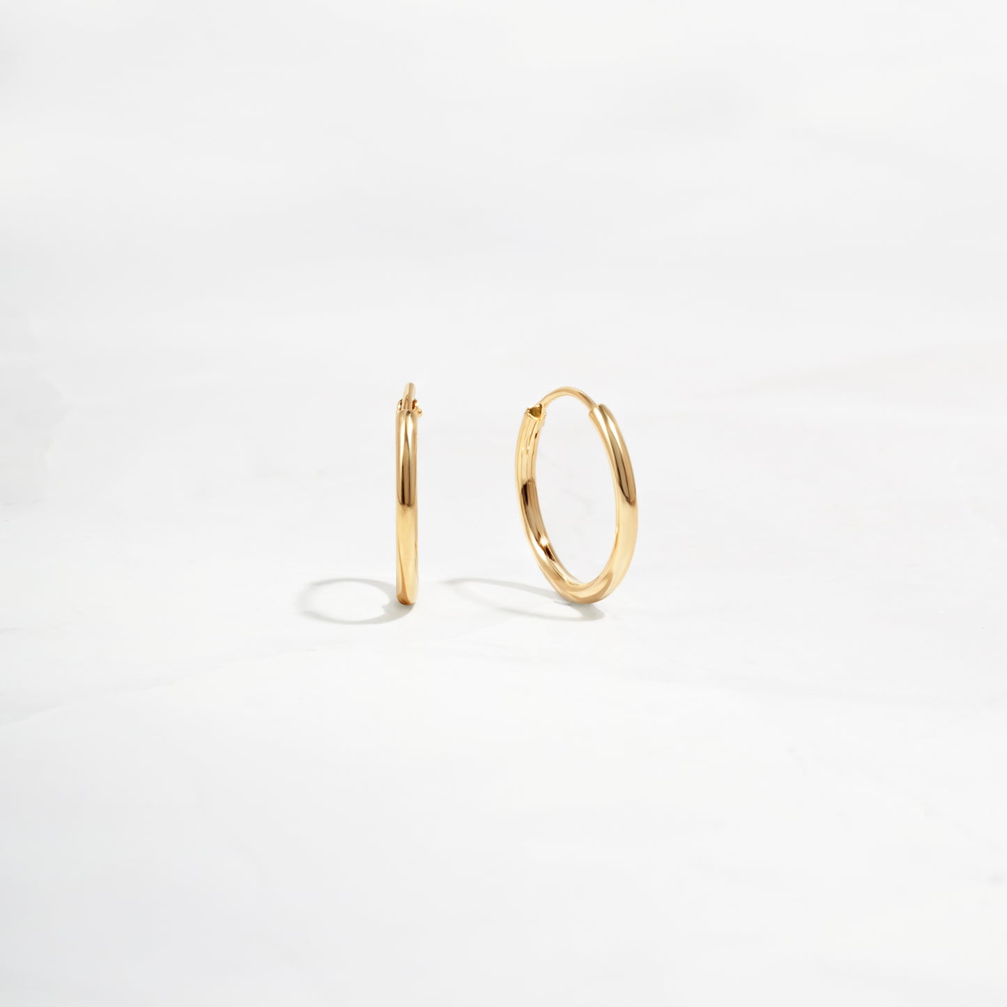 closeup of dainty gold everyday earrings