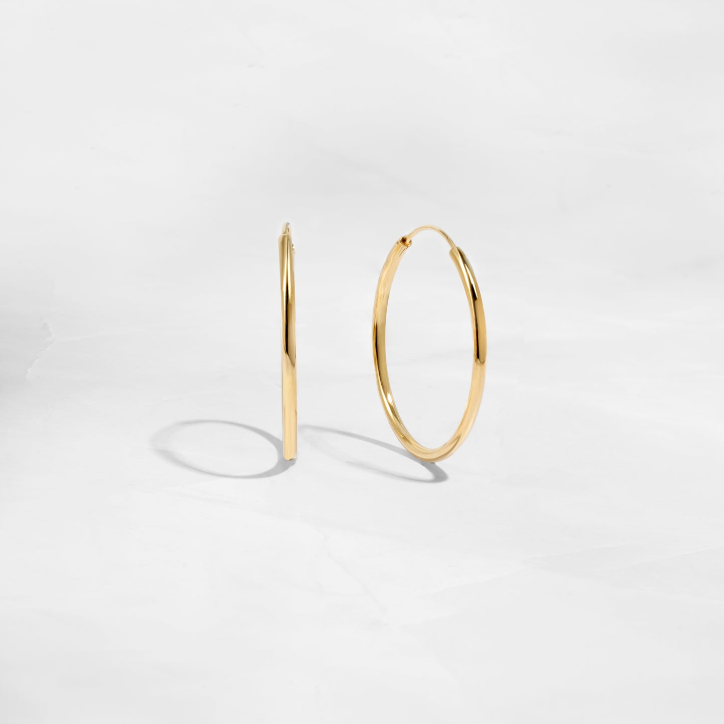 Closeup image of thin dainty hoop earrings