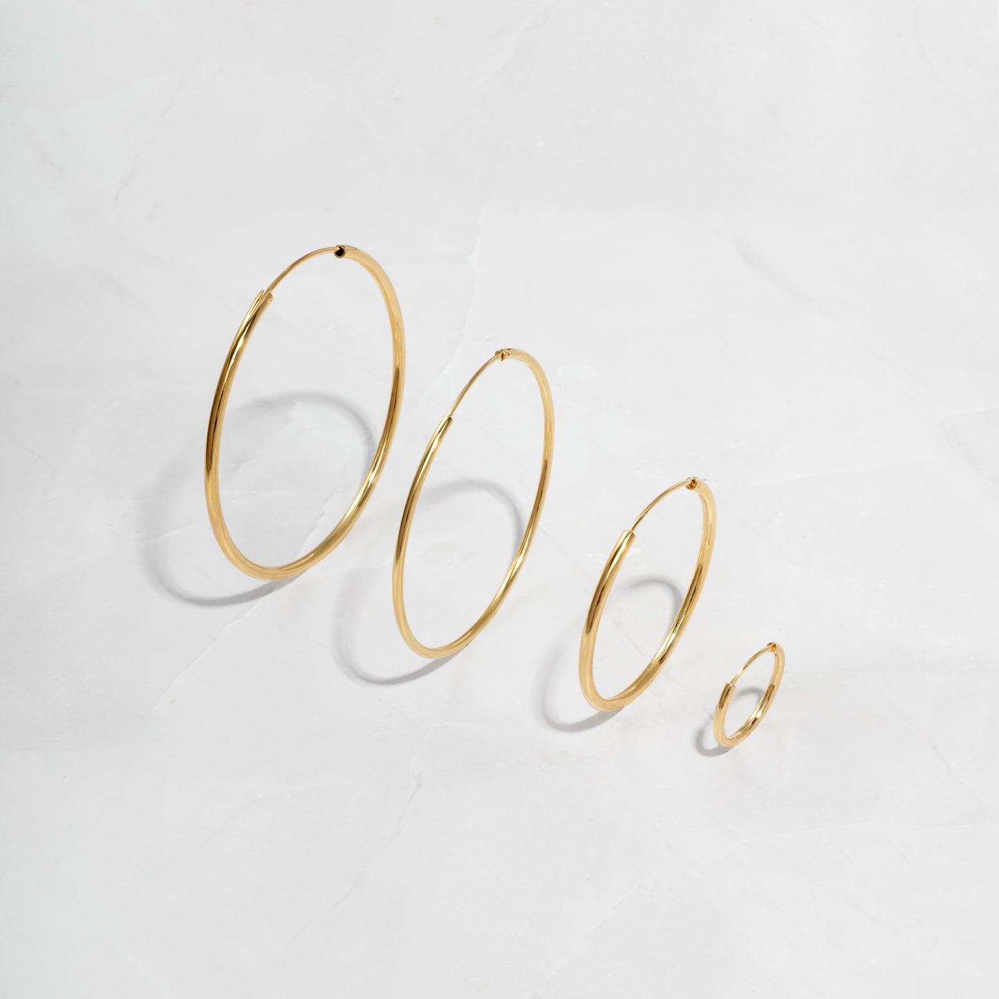 image showcasing various sizes available for the endless gold hoop earrings