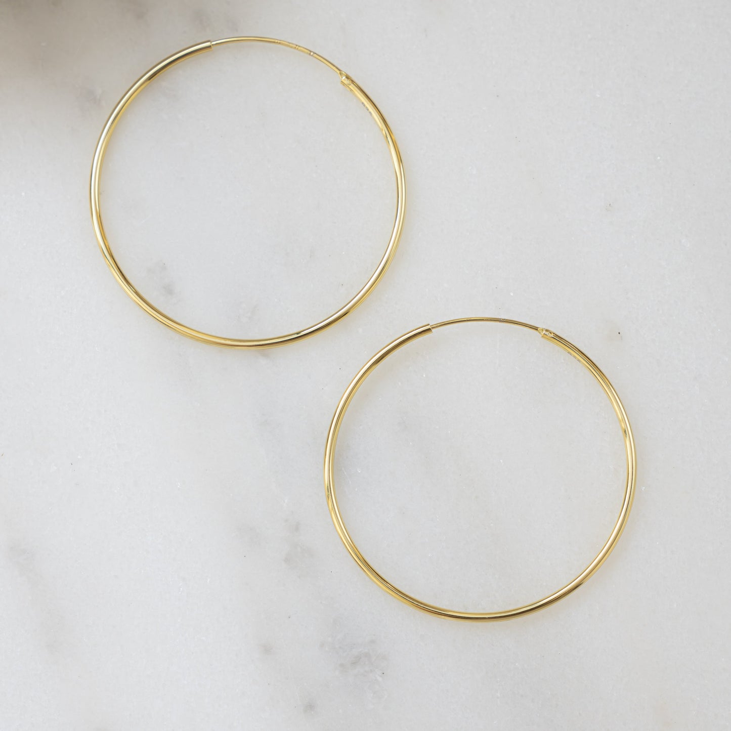 closeup image of gold threader earrings