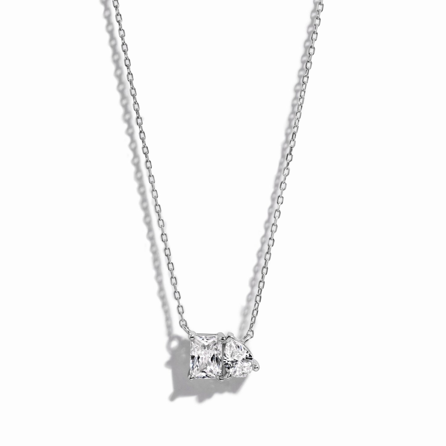 closeup image of sterling silver emerald cut and pear cut necklace