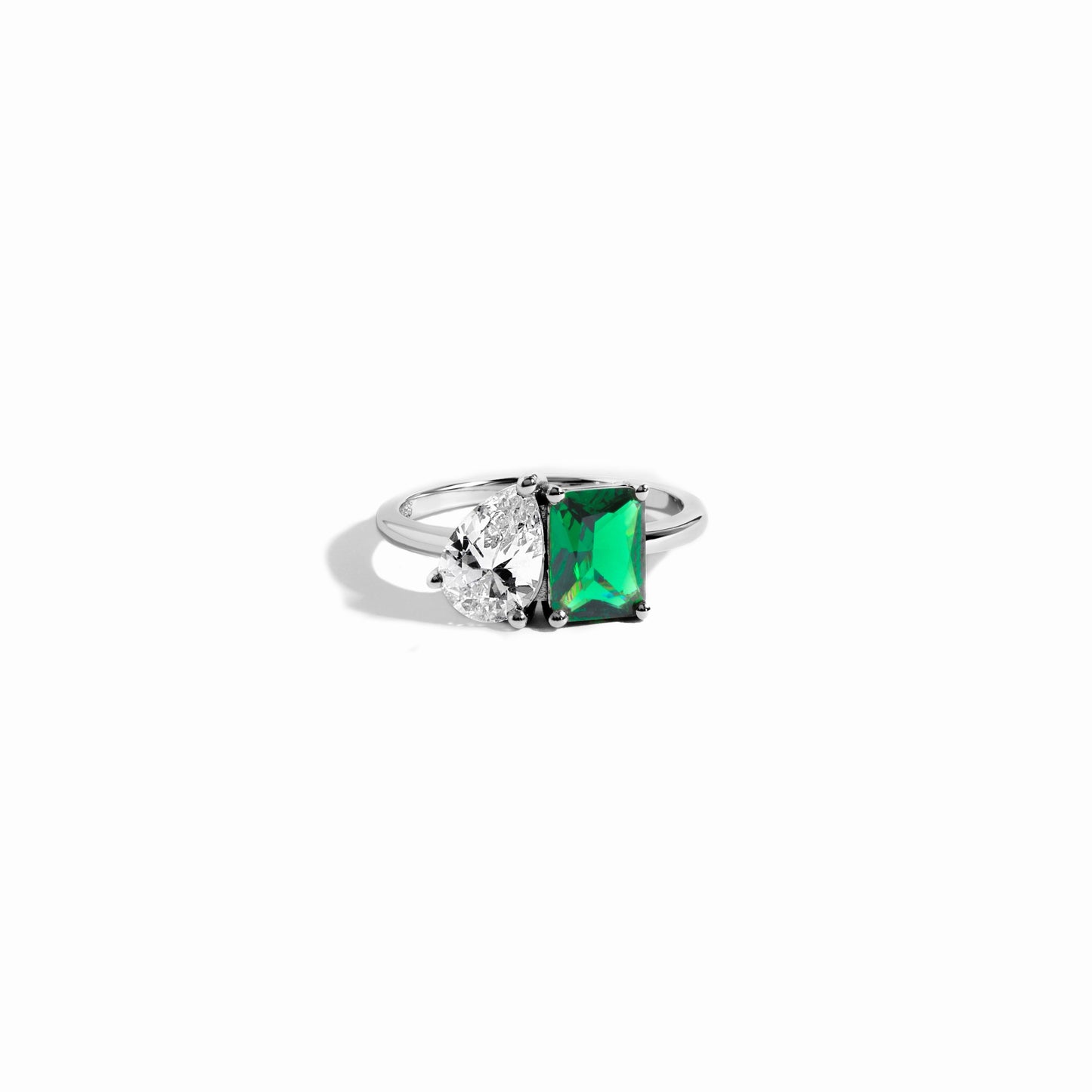 closeup image of emerald green toi et moi ring in sterling silver