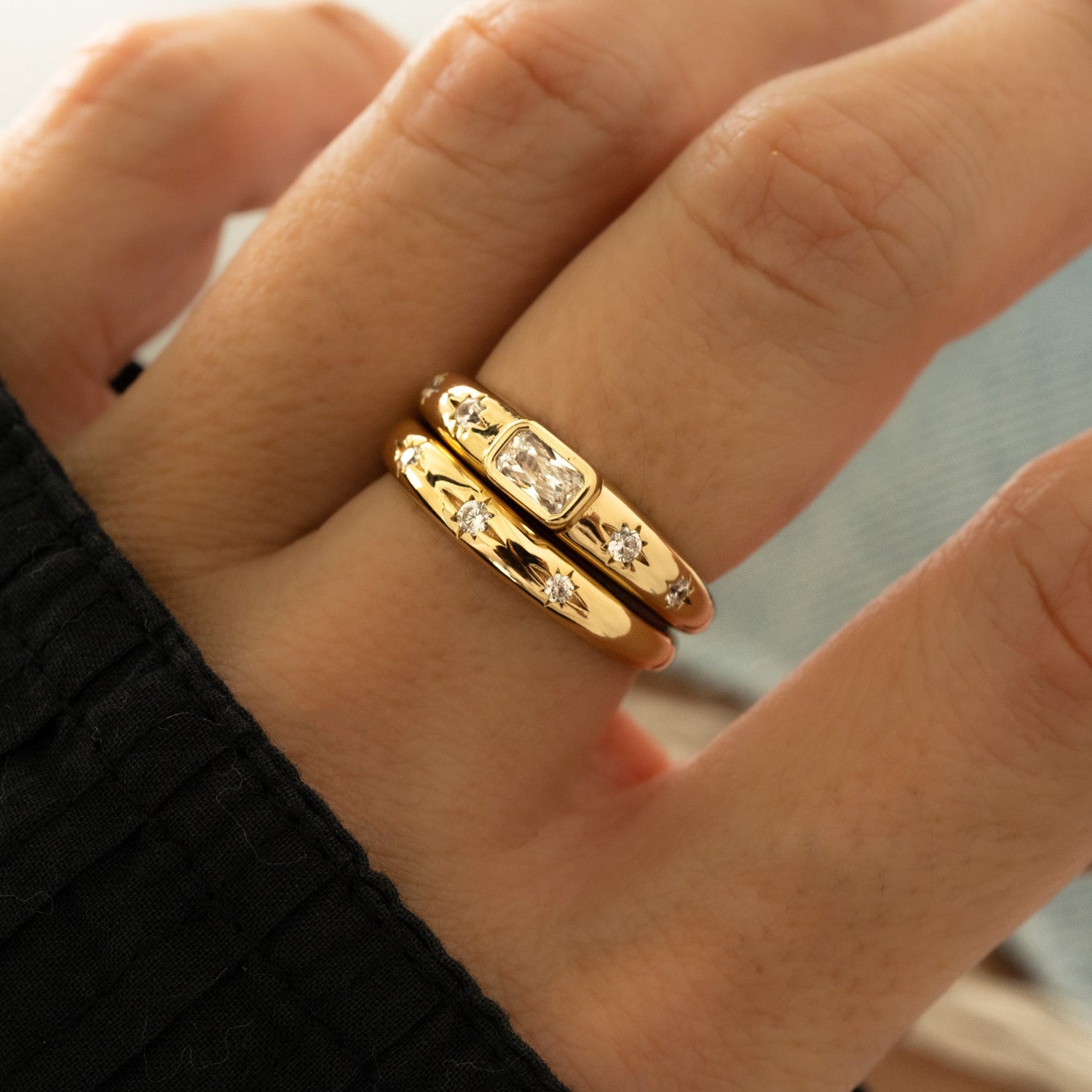 Closeup of Stacked Diamond Starburst Rings on model