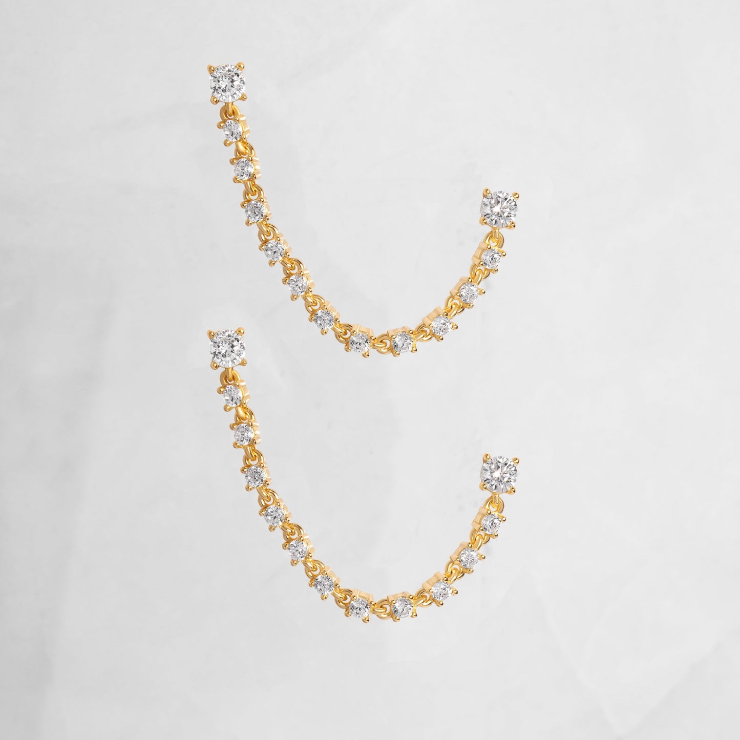 delicate stud earrings linking two-piercings with tennis chain design