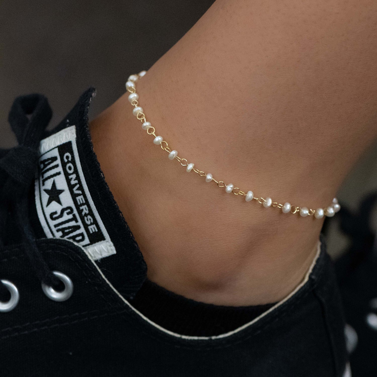 Model wearing pearl beaded ankle bracelet with sneakers