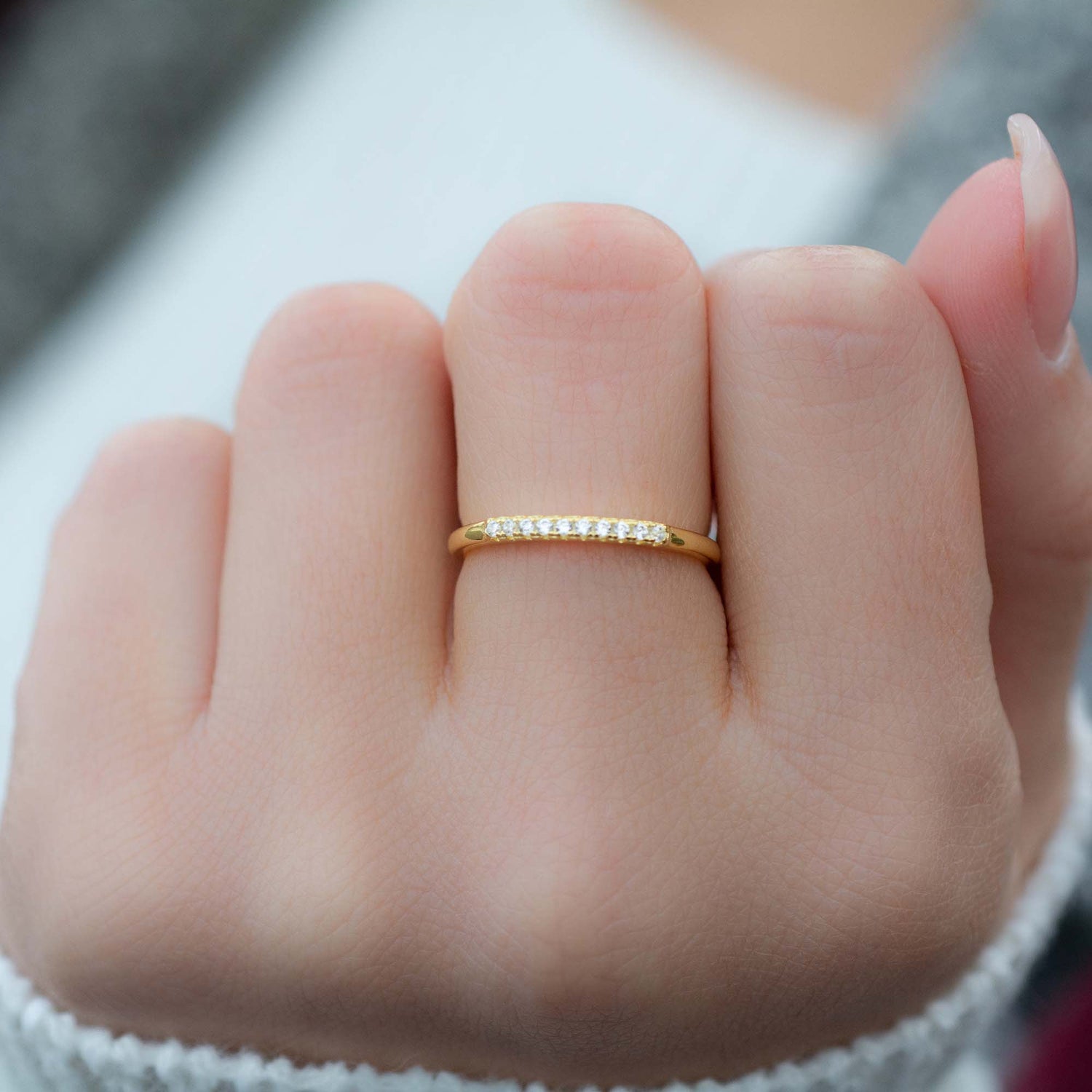 Model wearing dainty gold pave stacking ring.