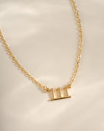 Gold angel number 111 necklace from Sami Jewels, close-up view showing the detailed pendant with chain.