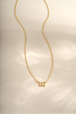 Gold angel number necklace from Sami Jewels featuring a delicate chain and a pendant with the number 111.