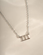 Close-up of Sami Jewels sterling silver Angel Number 111 necklace showing the engraved number pendant on a chain.