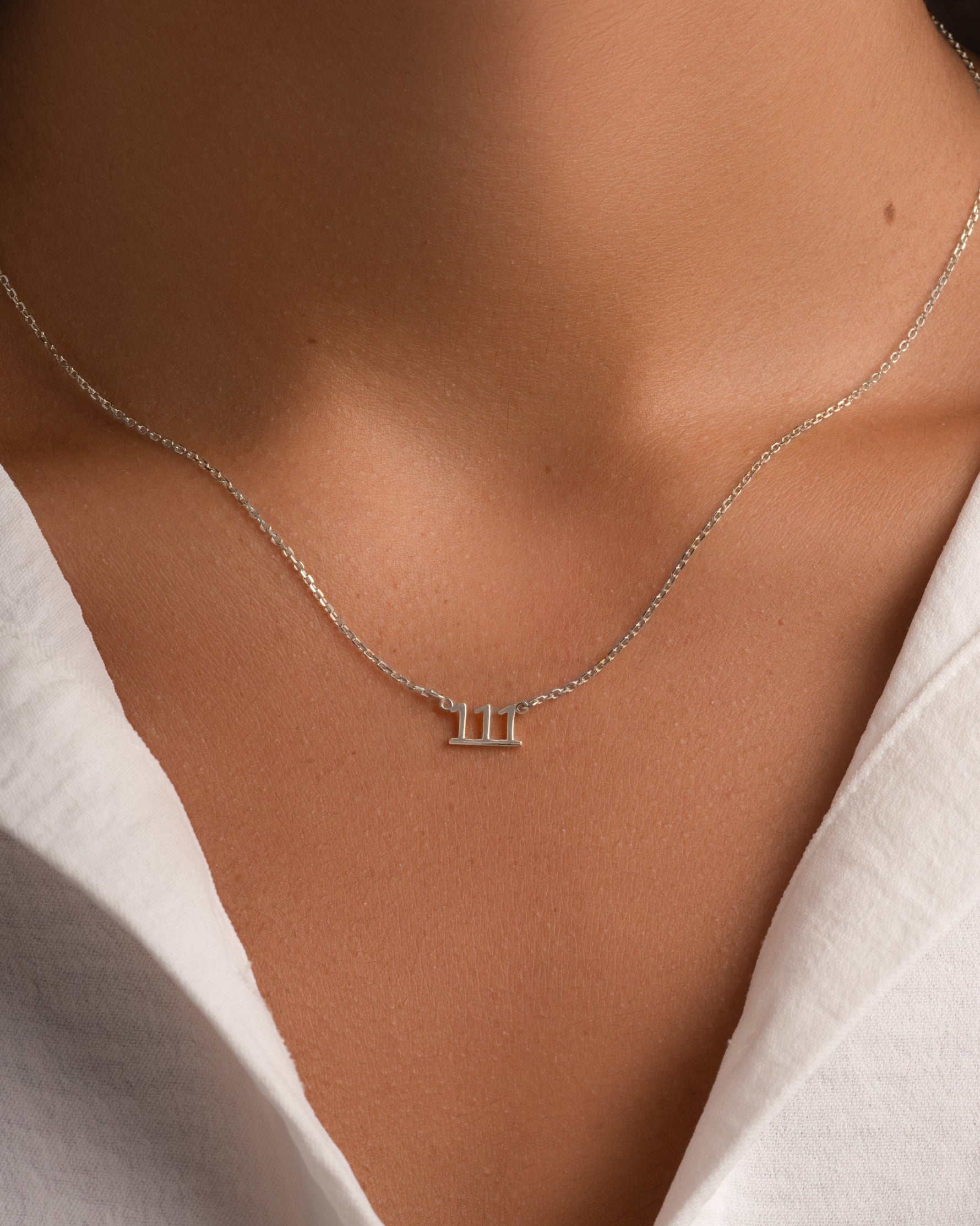 Sterling silver angel number 111 necklace by Sami Jewels displayed on a model, showcasing a delicate and stylish jewelry piece.