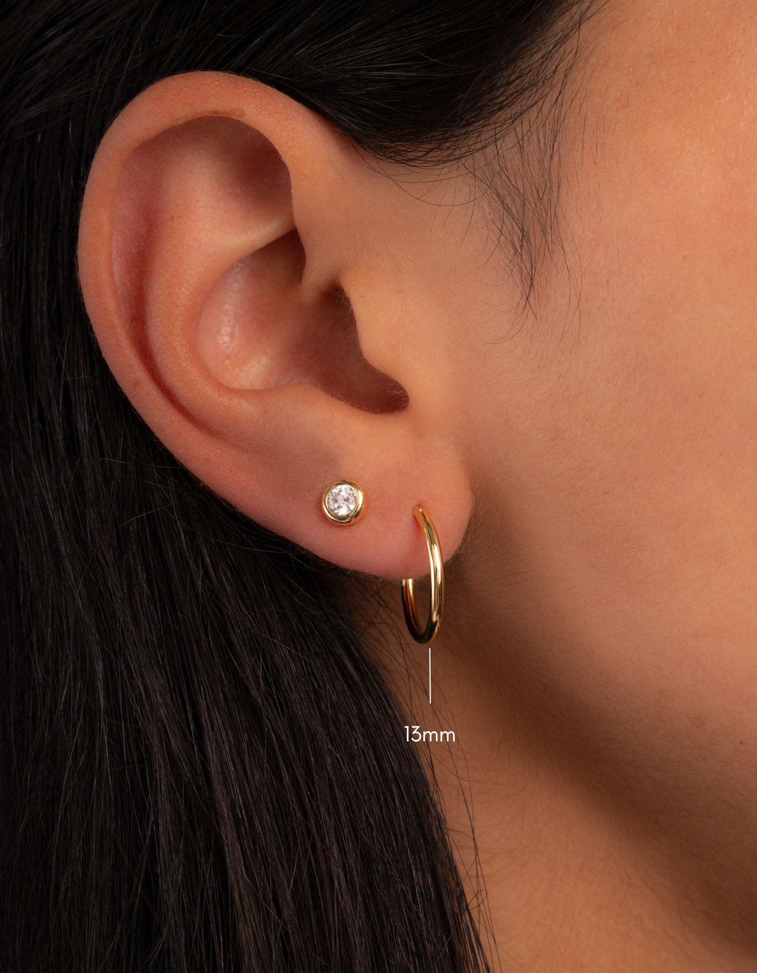 infinity hoop earring stack in gold, 13mm on models ear