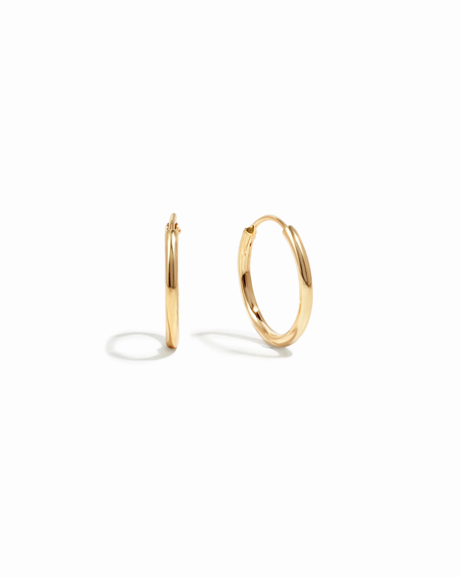 infinity hoop earrings in gold, 13mm on a white background