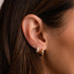 Earring stack on model featuring 15mm chunky gold hoop earrings, pave diamond basket hoop earrings, and solitaire stud earrings.