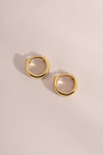Side view of 14K solid gold chunky hoop earrings on a neutral background