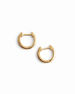 Pair of 14K solid gold 8mm pavé diamond huggie earrings white background