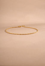 14K solid gold bar station chain bracelet styled flat lay on neutral background