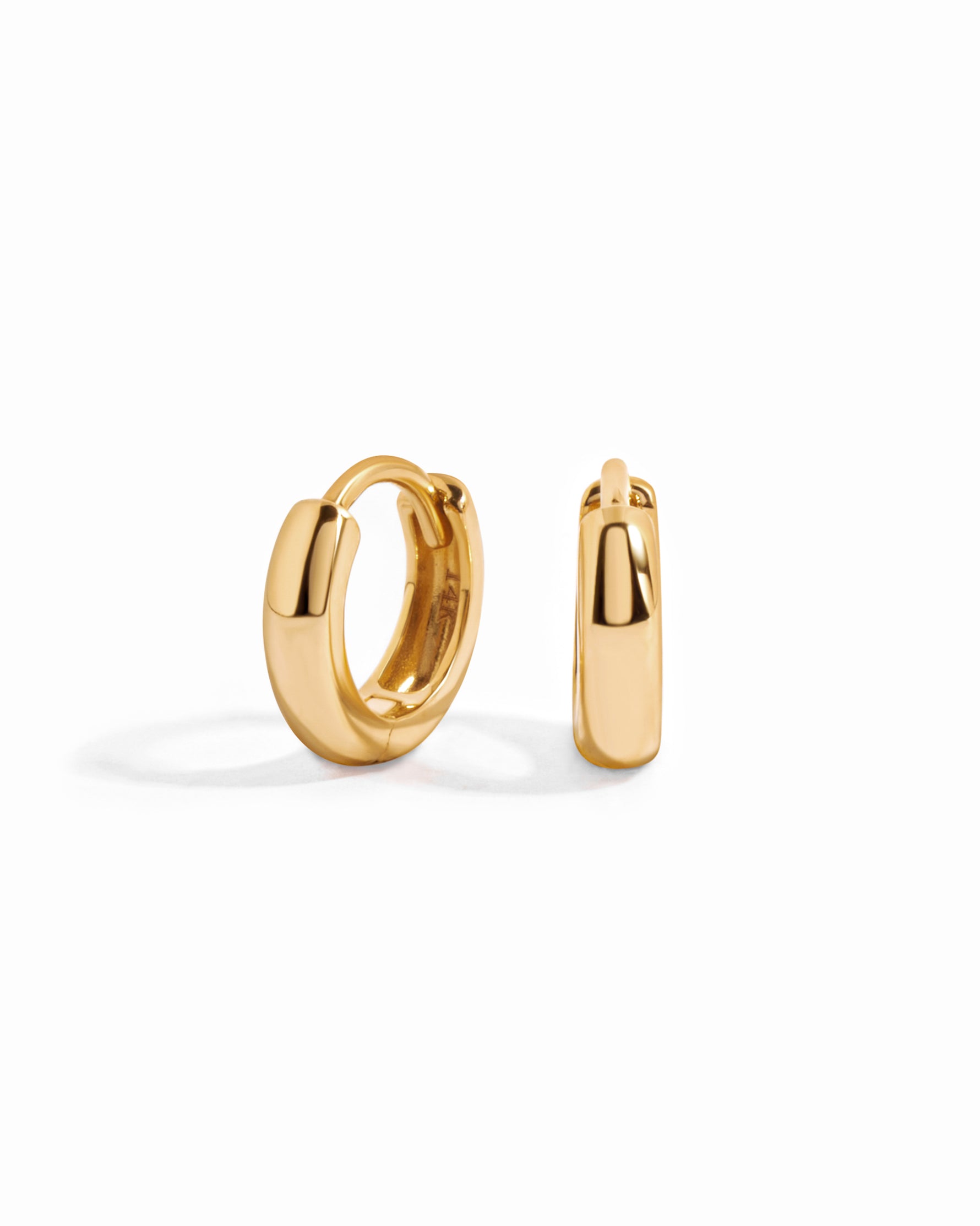 14K solid gold chunky huggie earrings from Sami Jewels, showcasing a bold and stylish hoop design in close-up.