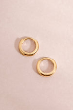 14K solid gold chunky huggies earrings with a bold, modern design from Sami Jewels, shown close-up on a plain background.