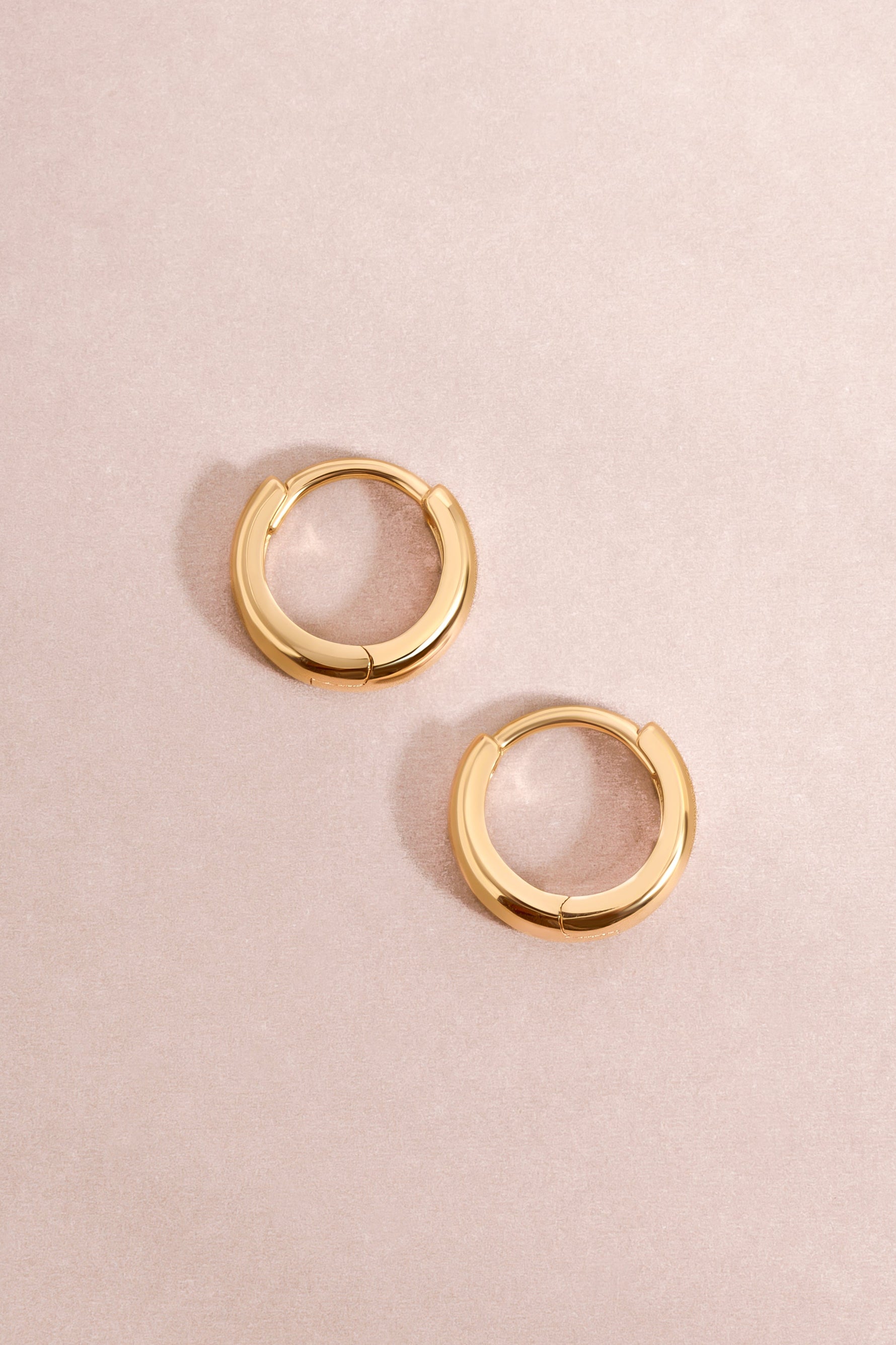 14K solid gold chunky huggies earrings with a bold, modern design from Sami Jewels, shown close-up on a plain background.