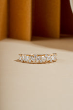 Fine jewelry diamond ring with multiple stones on neutral background