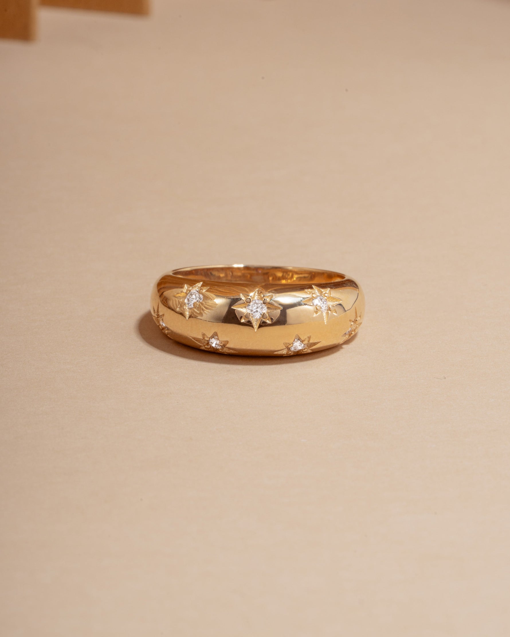 14k gold dome ring with star set lab grown diamonds, modern statement ring on neutral background