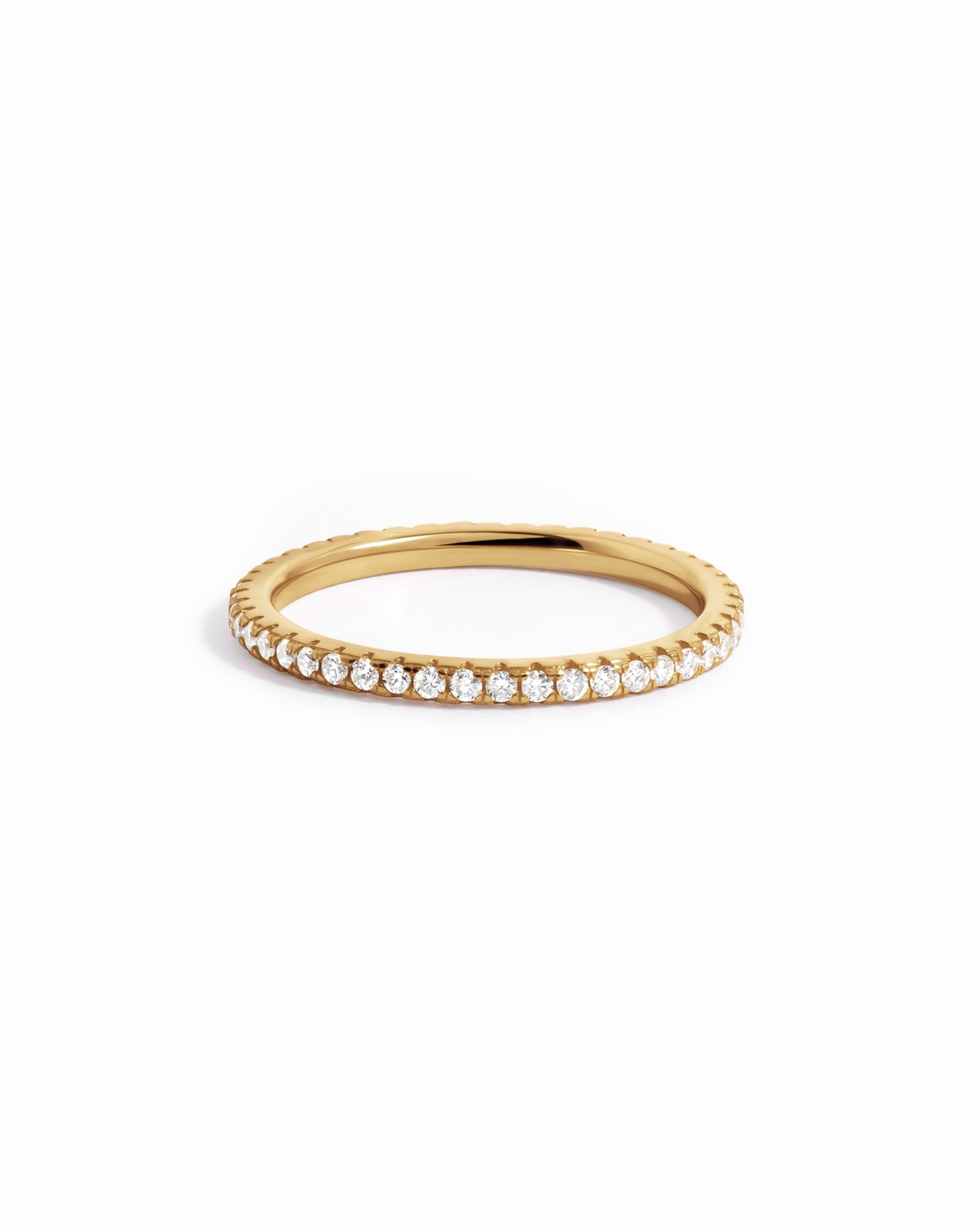Solid 14k gold diamond eternity ring with pavé diamonds on white background