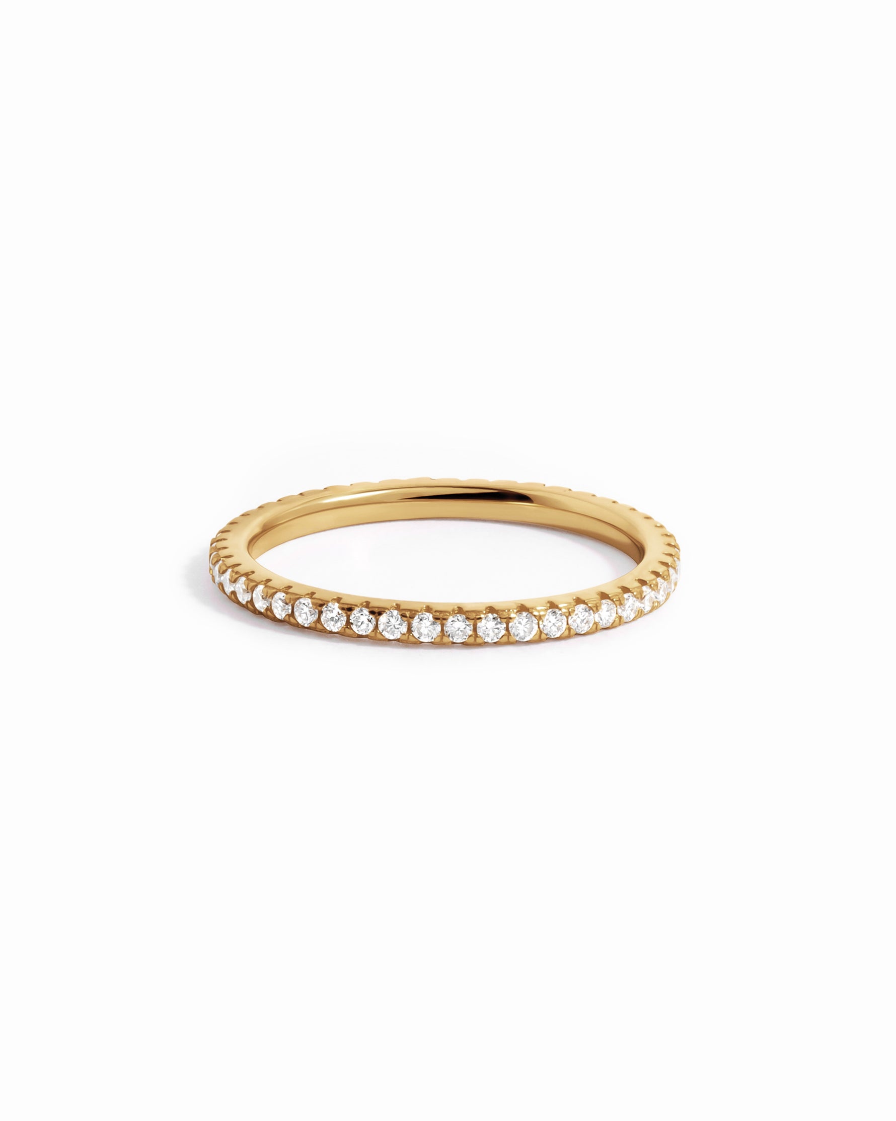 Solid 14k gold diamond eternity ring with pavé diamonds on white background