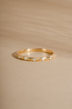 14K solid gold stacking ring with seven lab grown diamonds and delicate accents on neutral background