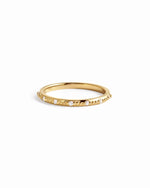 Delicate 14K solid gold diamond stacking ring on white background