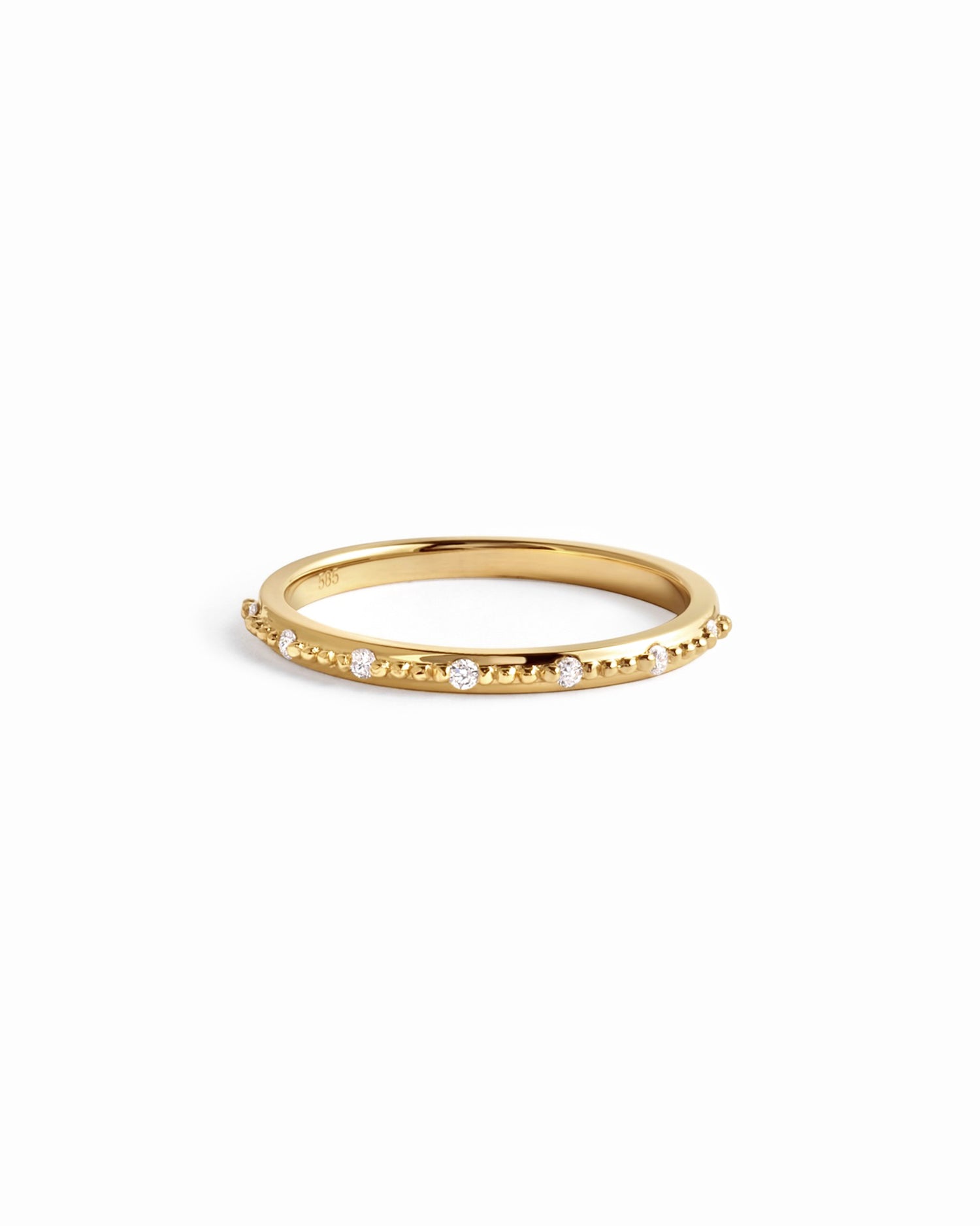 Delicate 14K solid gold diamond stacking ring on white background