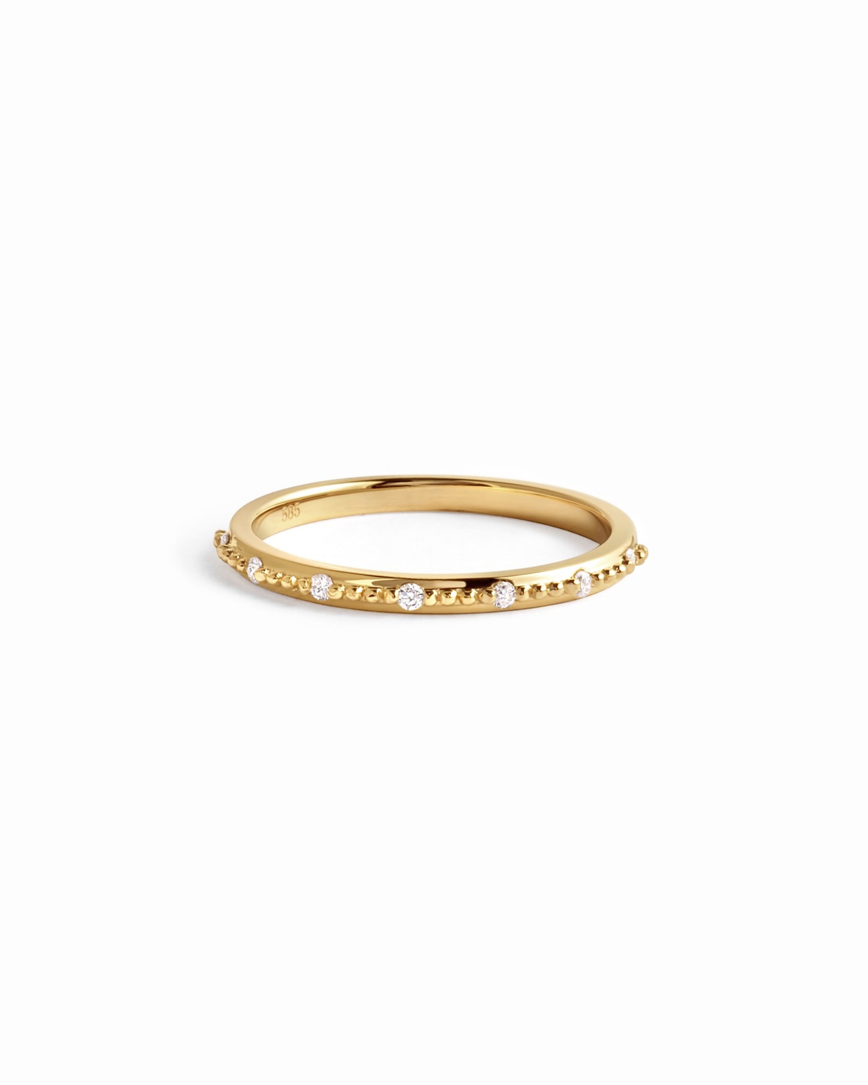 Delicate 14K solid gold diamond stacking ring on white background