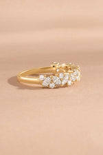 Solid gold multi stone diamond ring side view on neutral background