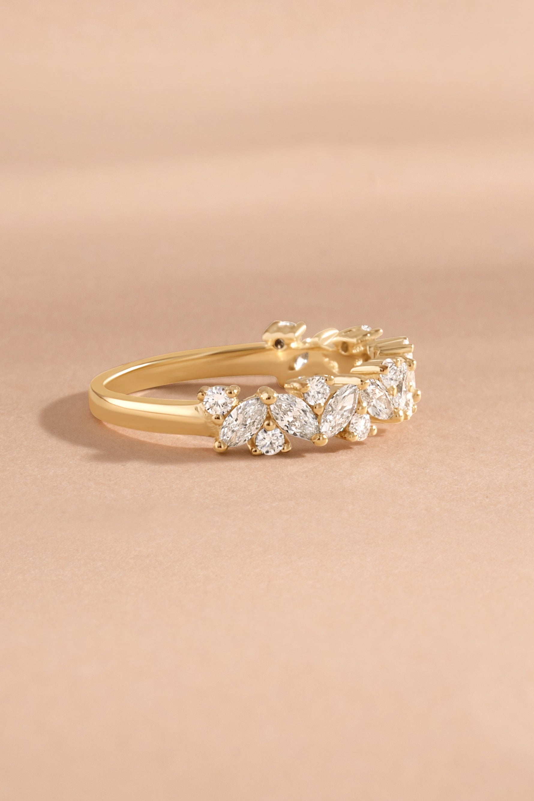Solid gold multi stone diamond ring side view on neutral background