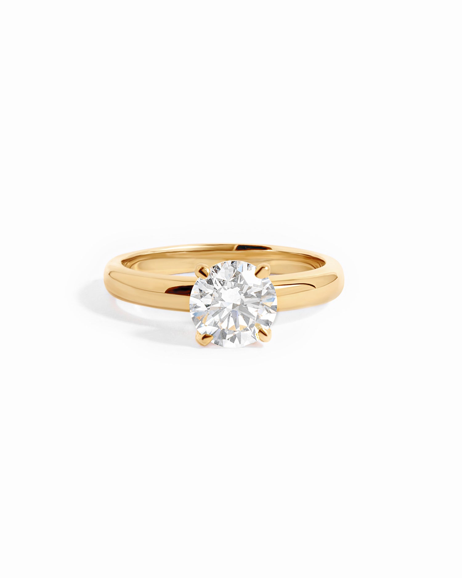 Solid 14k gold round solitaire lab diamond ring on white background