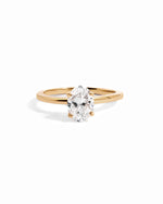 Solid 14k yellow gold oval solitaire lab diamond ring on white background
