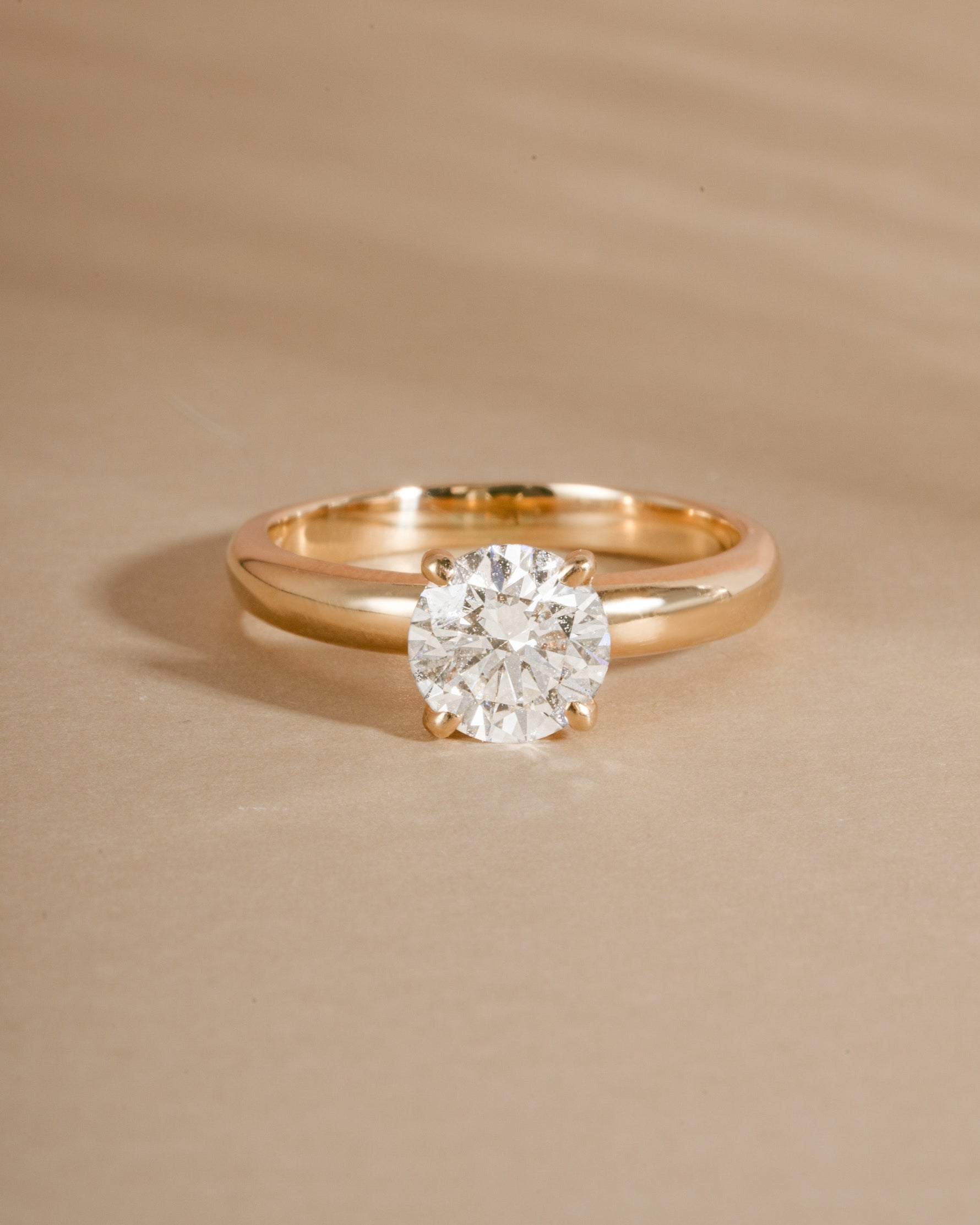 Minimalist round lab diamond ring crafted in solid 14k gold on beige background