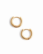Pair of 14K solid gold hoop earrings on a white background