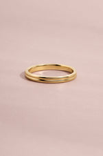 14K solid gold double row band on light pink background