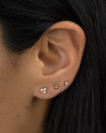 Gold 3-ball stud earrings by Sami Jewels worn in second ear piercing, showcasing minimalist jewelry style.